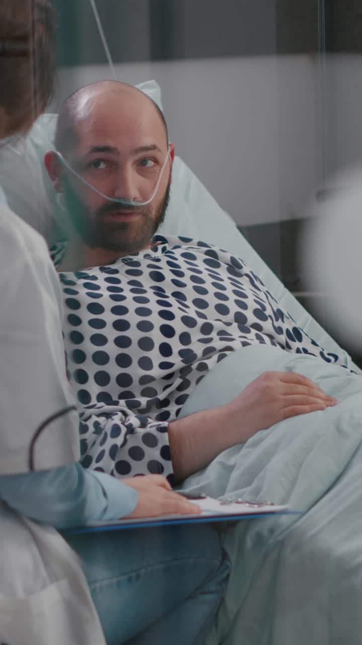 Vertical video: Doctors team monitoring man explaining disease symptom