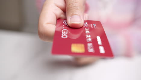 detail of female hands selecting credit card to make purchase