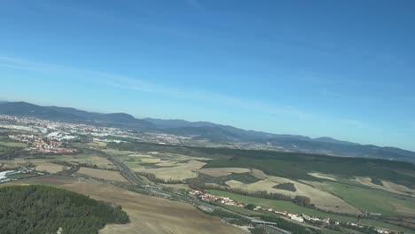 aerial panoramic view of pamplona city, in spain, as seen by the pilots in a real time flight, in a sunny bright morning