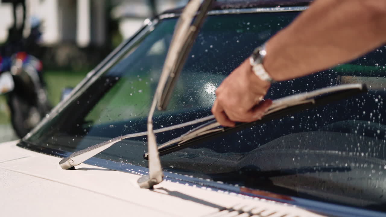 Lifting up windshelf wipers on a sunny summer day in Canada