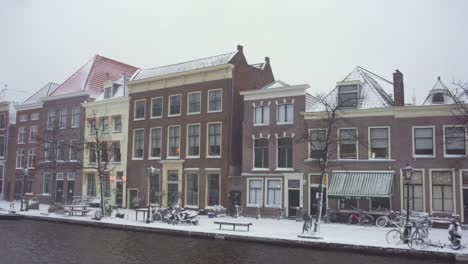 leiden city buildings in winter snow on rijn riverside, netherlands, panoramic