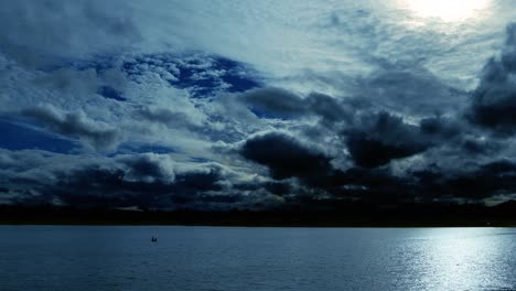 time lapse of a dramatic sky at dusk, with normal speed for the lake