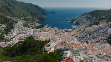 aerial view of a picturesque coastal town with white buildings and harbor