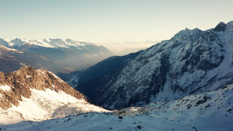 Flying-over-Snowy-Mountains-in-wintertime-Unveiling-Beautiful-Valley