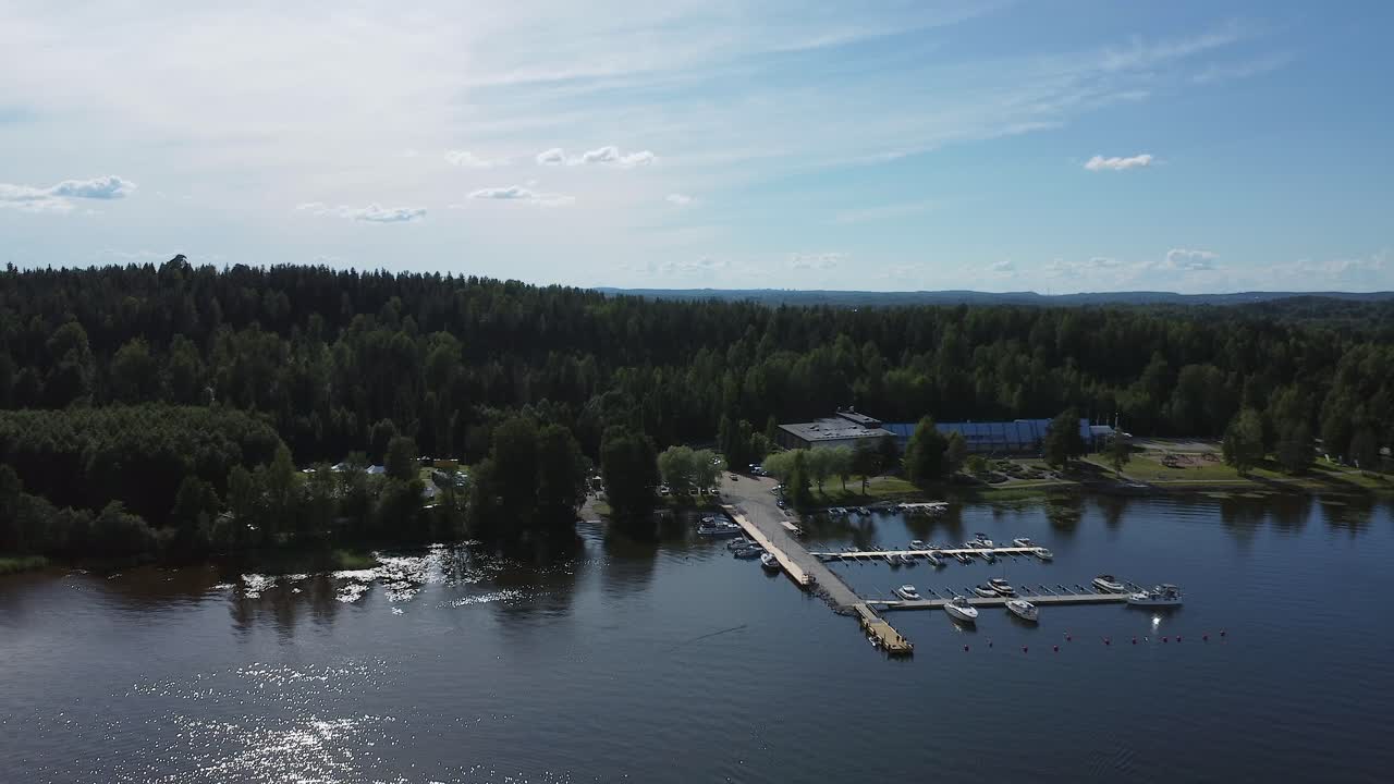 Motorboats moored at small marina in national park lake in Finland