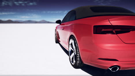 red convertible car on a white desert landscape