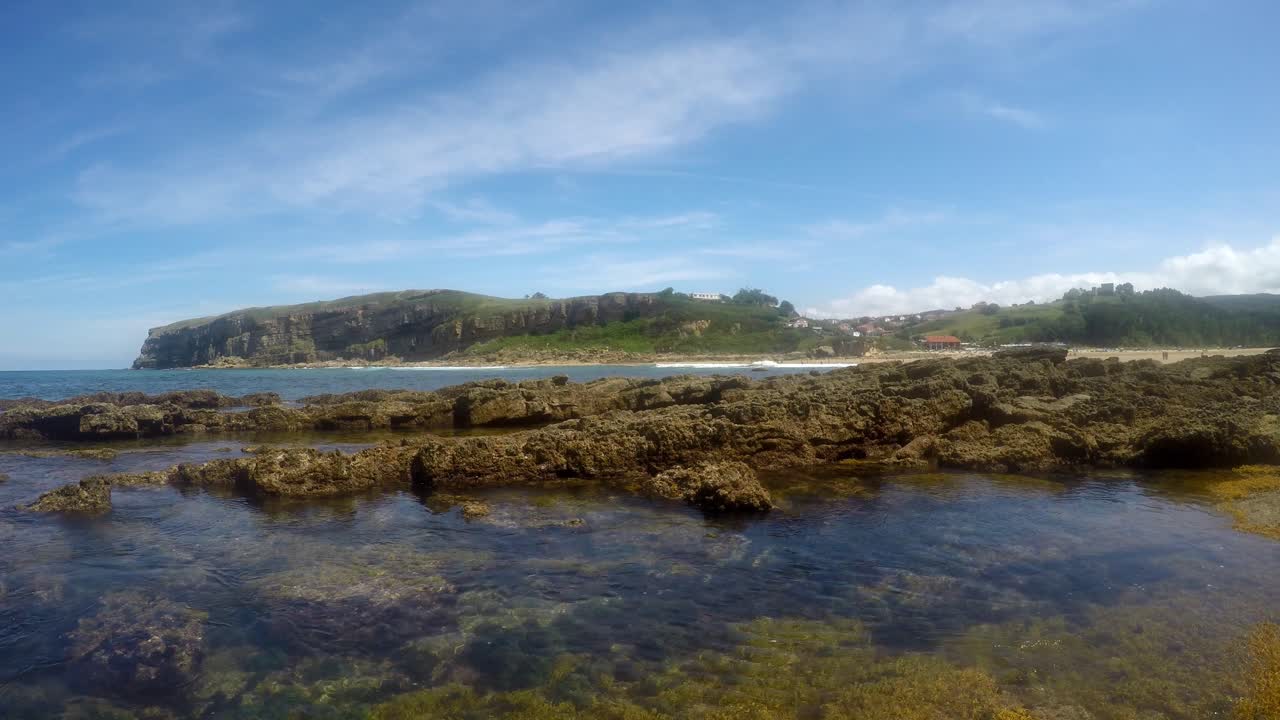 Rocky shore with tide pools at Luaña Beach, Cóbreces on the Cantabrian Sea coast