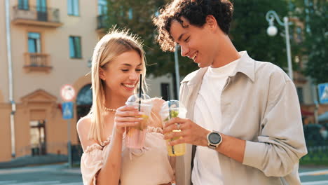 young couple enjoying drinks outdoors