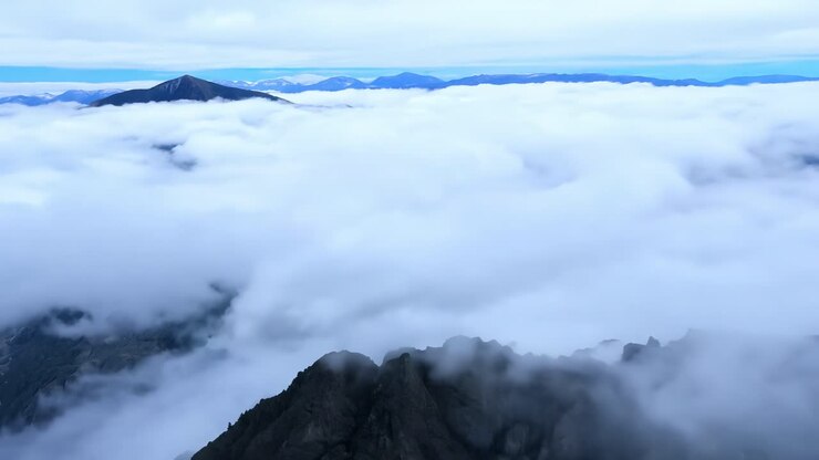Aerial view of a mountain range with clouds