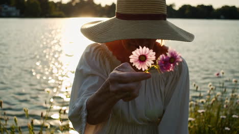 Elderly Woman with Flowers by the Lake at Sunset