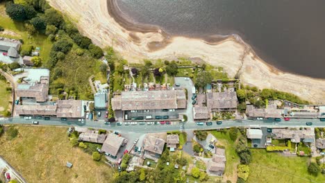 drone aerial footage of a rural industrial yorkshire town village with old mill and chimney stack