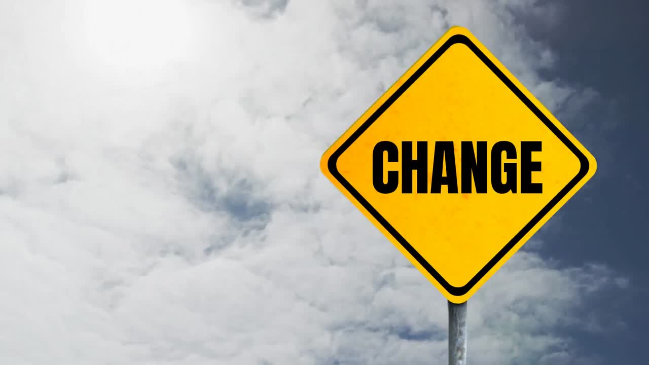 Animation of  yellow road sign with the sky in the background