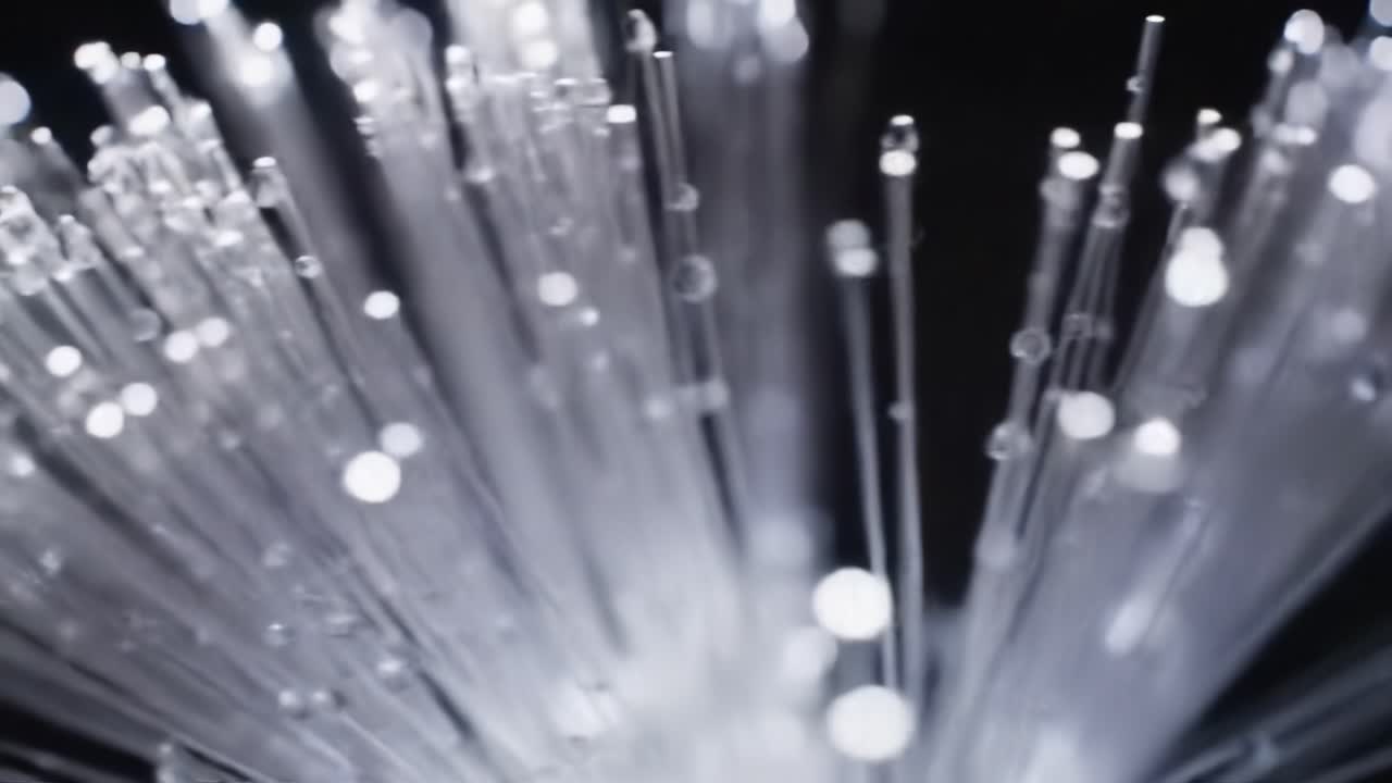 Colorful light patterns emerge from fiber optic strands as they glow. The shimmering display creates a captivating ambiance during nighttime.