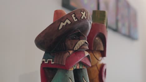 handcrafted wood statue with sombrero marked mexico in close up view
