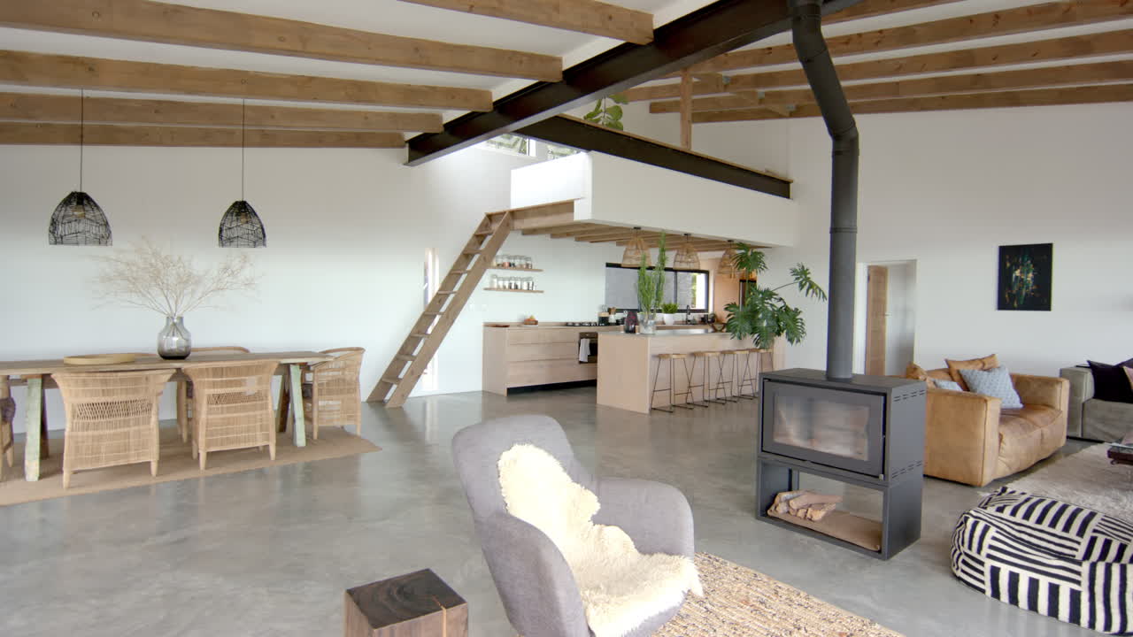 Modern open-concept living room with cozy furniture and wood-burning stove