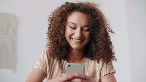 Close-up-of-beautiful-teenage-girl-using-a-smart-phone