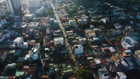 Drone-circling-traffic-on-the-Radial-Road-4,-in-sunny-Manila,-Philippines