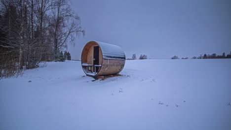 time lapse of an outdoor cabin hotel near a forest covered in snow in cold winter