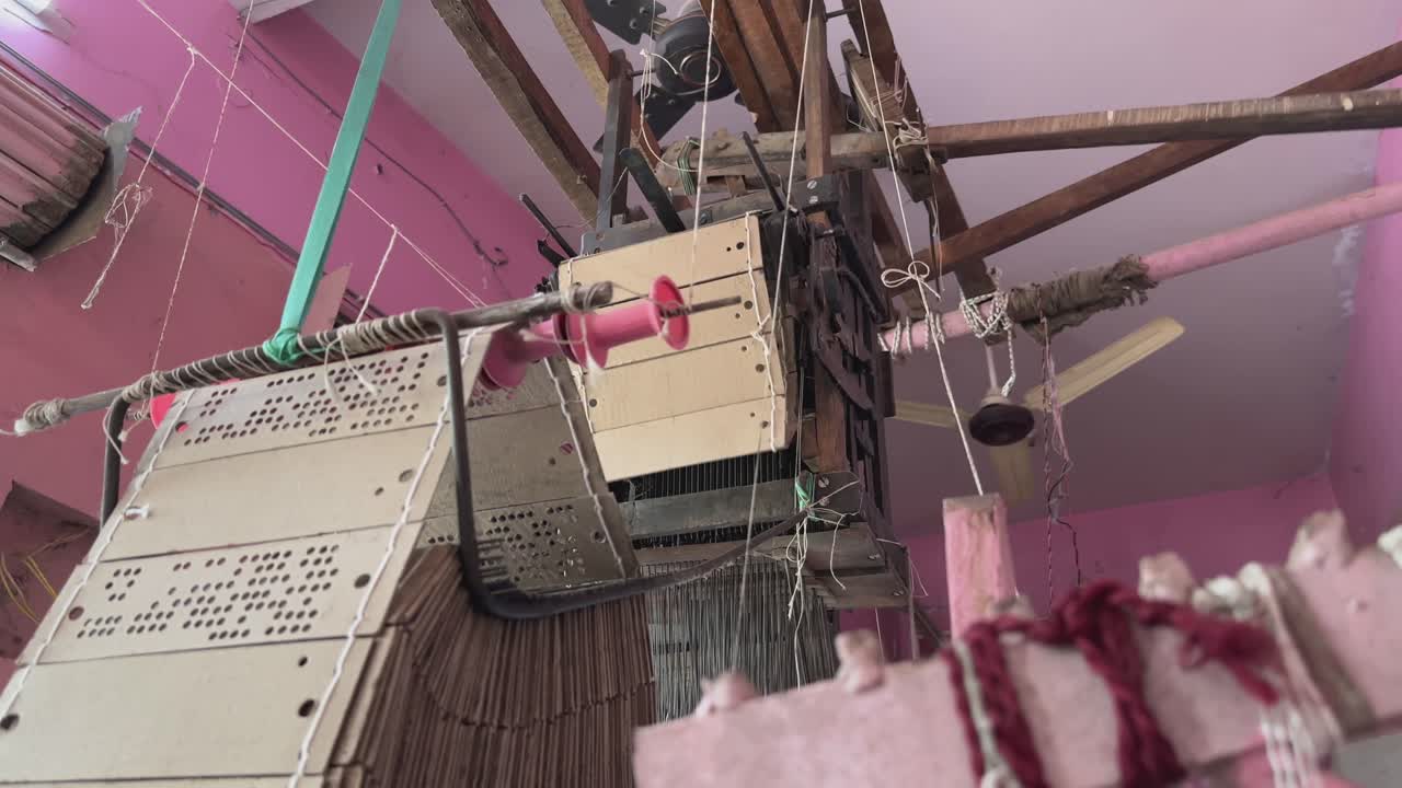 Closeup of perforated cardboard used in handloom, punched with specific patterns in which threads are raised or lowered to create intricate designs on fabric