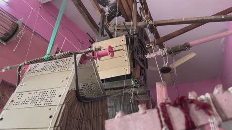 closeup of perforated cardboard used in handloom, punched with specific patterns in which threads are raised or lowered to create intricate designs on fabric