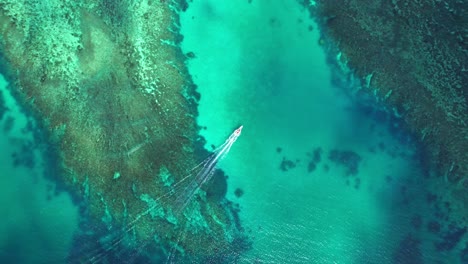 Barco-Con-Vista-De-Pájaro-Navegando-Sobre-Arrecifes-De-Coral-Turquesa,-Islas-Yasawa,-Fiji