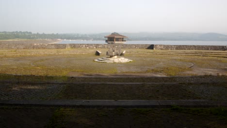 wide-shot-of-Carsington-Water-overgrown-viewing-area-with-the-Water-Valve-Tower,-Draw-Off-Tower-in-the-Background