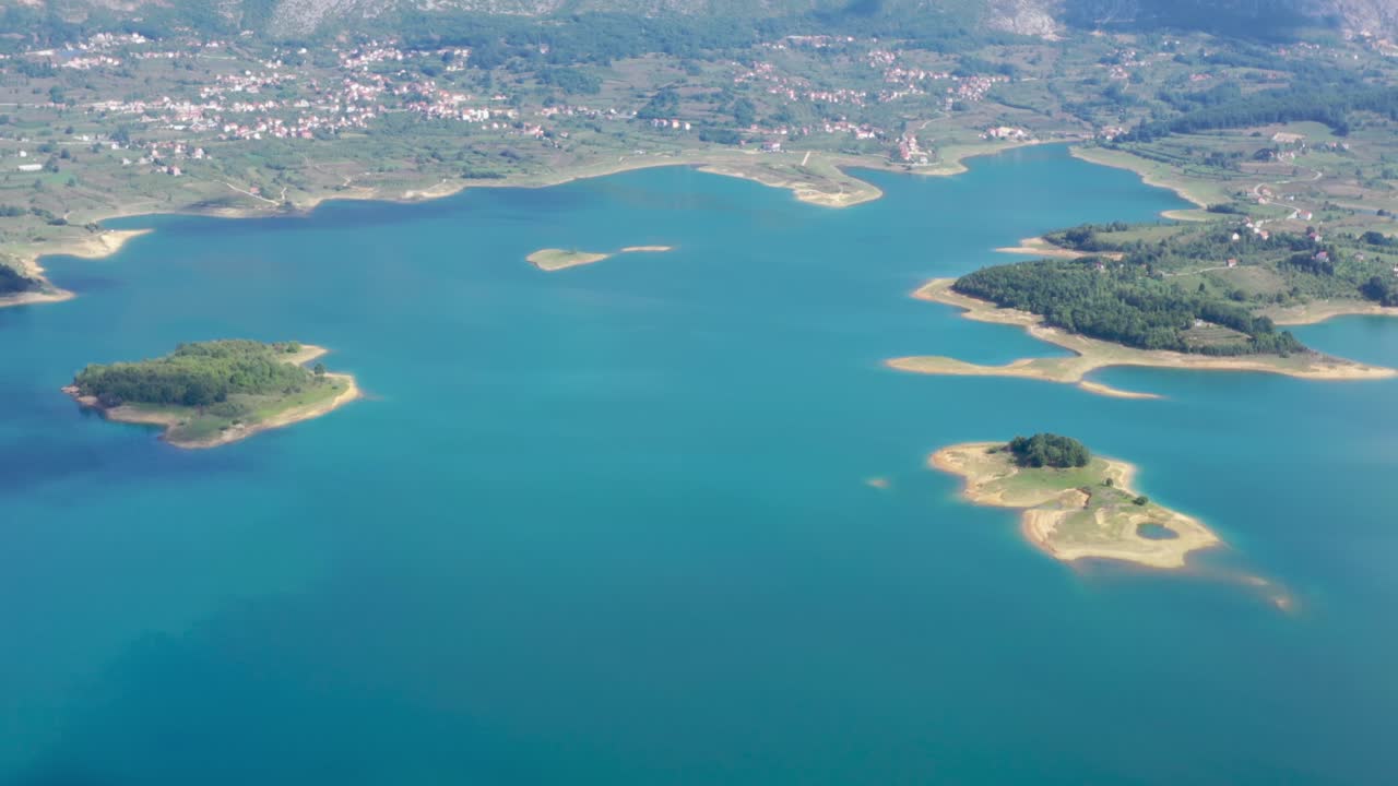 Town of Ripci on the northern shore of Rama Lake in Bosnia and Herzegovina, Aerial dolly out high shot