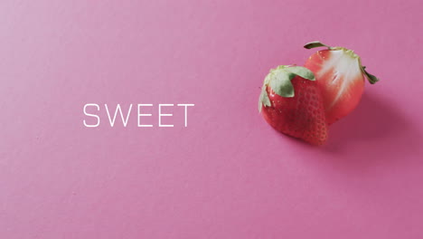 animation of sweet text over halved strawberry on pink background