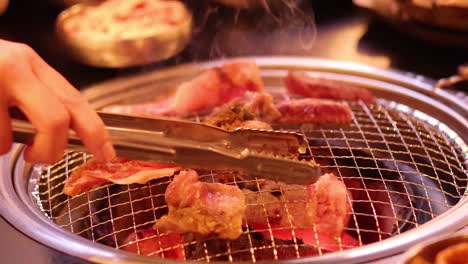 meat being grilled on a barbecue grill