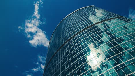 corporate building timelapse, sun and clouds reflections on glass