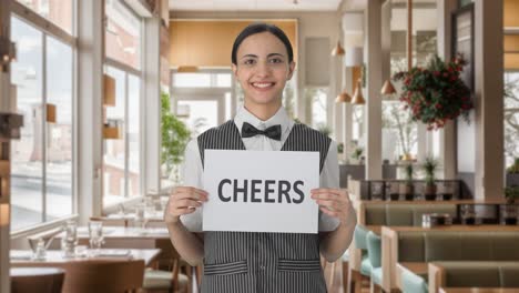 happy indian woman waiter holding cheers banner