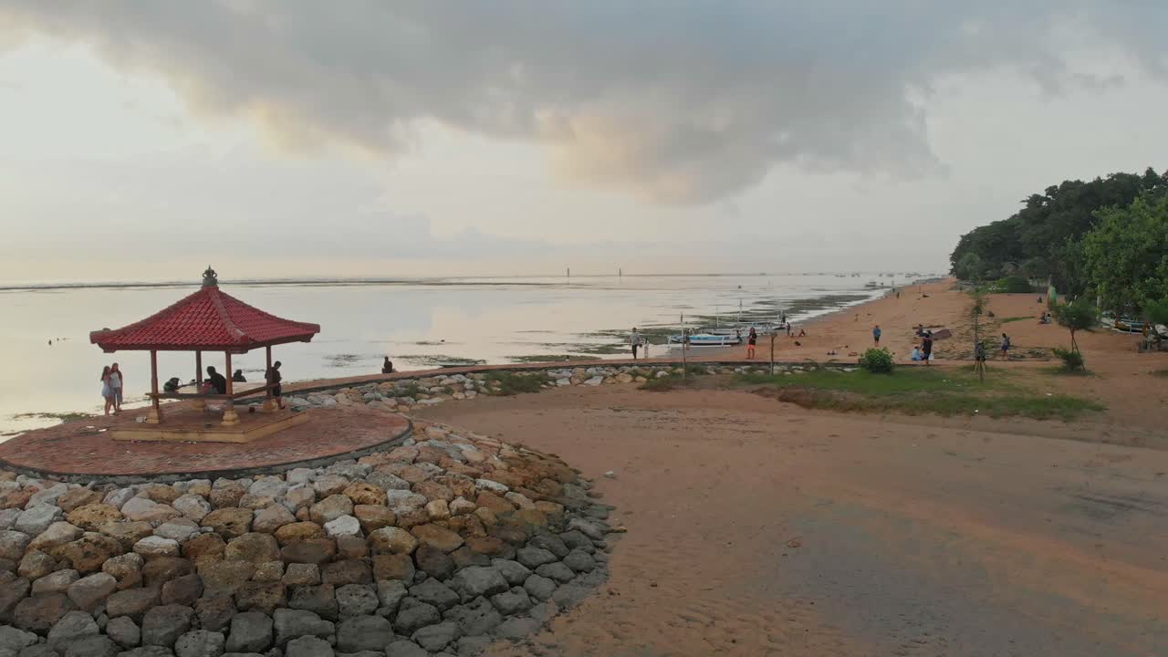 Barche sulla tranquilla costa all'alba di Sanur. Indonesia, Bali
