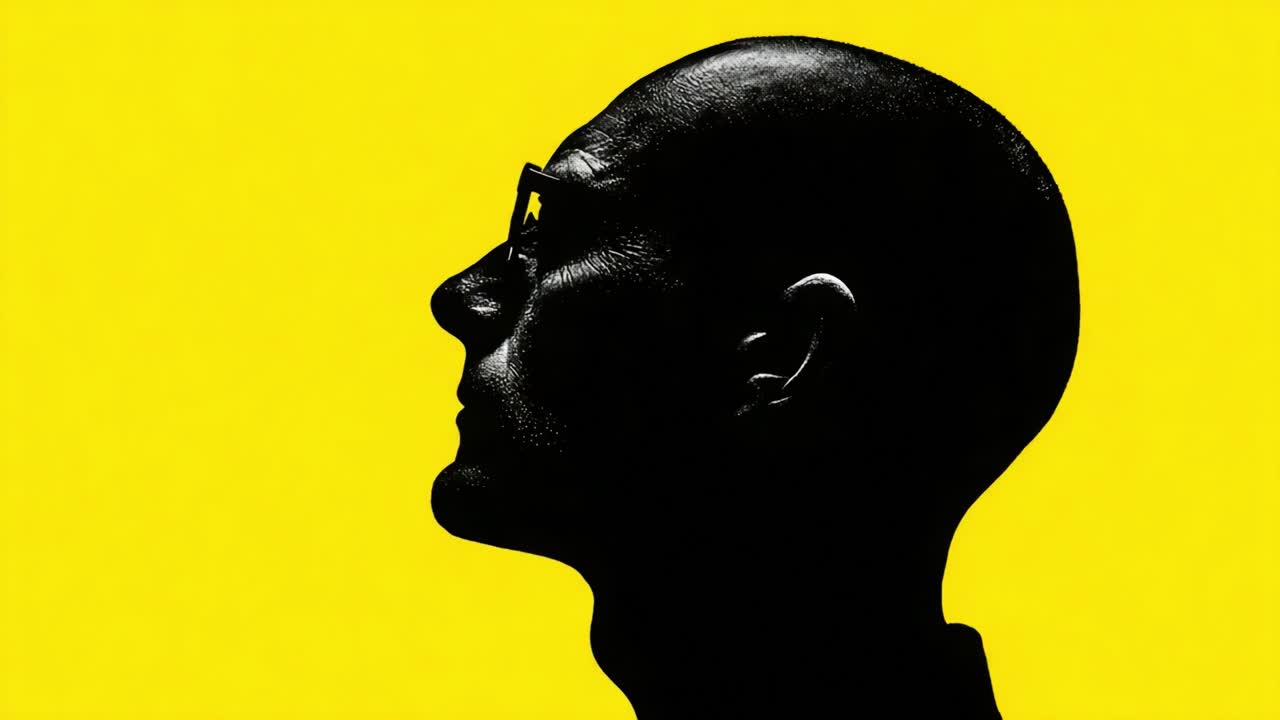 A Creative Exploration of Silhouettes: Capturing the Intriguing Profile of a Bald Individual Against a Vivid Yellow Background
