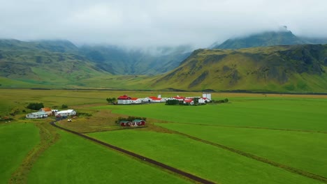 Mit-Einer-4K-Drohne-Aufgenommene-Luftaufnahmen-Zeigen-Die-Malerische-Naturschönheit-Der-Berge,-Des-Grüns-Und-Der-Bunten-Häuser,-Die-über-Die-Gesamte-Landschaft-Verstreut-Sind