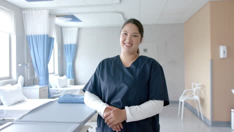 portrait of happy plus size caucasian female doctor in hospital ward, copy space, slow motion