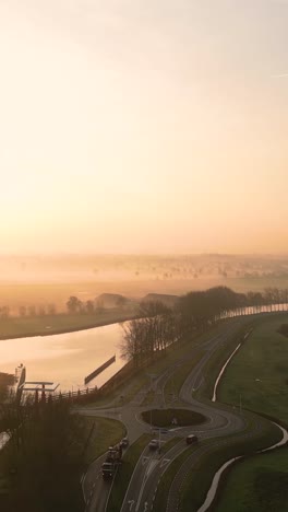 misty sunrise over dutch canal