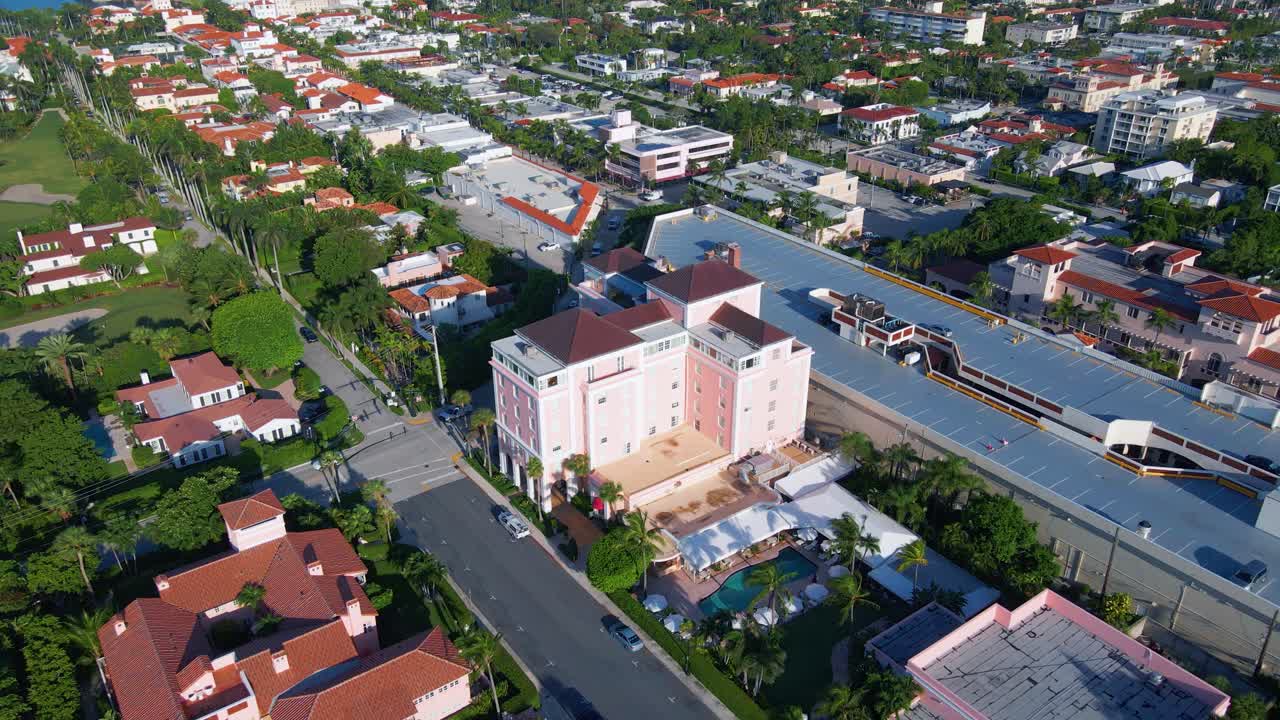 Aerial view away from the Colony hotel, on a sunny morning, in Palm Beach, Miami, Florida, USA - pull back, drone shot