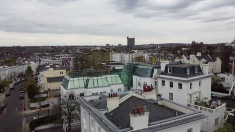 aerial view of apartment blocks and mirrored windows on rooftop terrace in notting hill, london