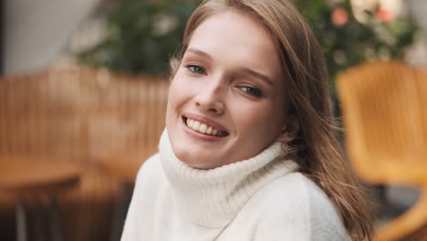 caucasian woman smiling at the camera.