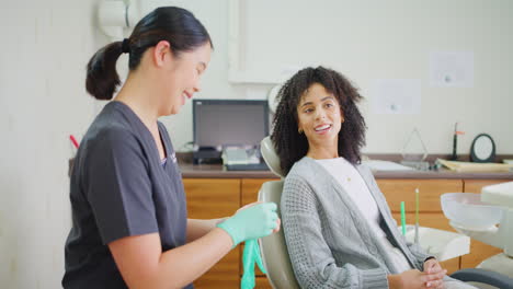 a female dentist consulting a patient visiting