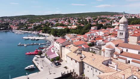 krk village at krk island, croatia - aerial drone view of the church, cathedral, city walls, port, boats and boulevard at the adriatic sea