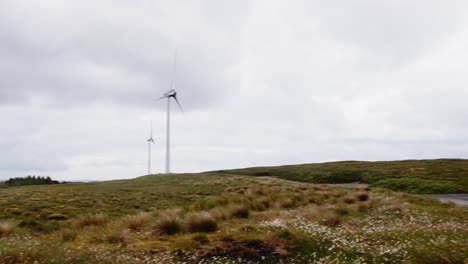 panning shot of the moor around a wind farm on the outer hebrides