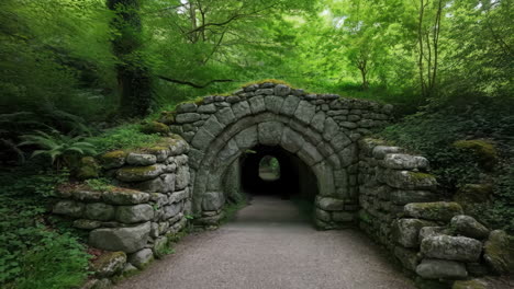 stone archway path in a lush green forest