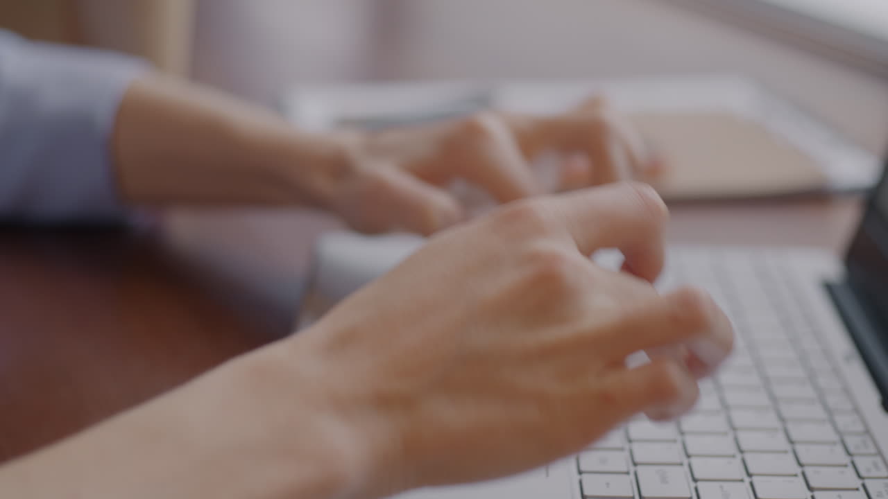 Woman Typing on Laptop