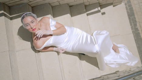 elegant bride lying on stairs