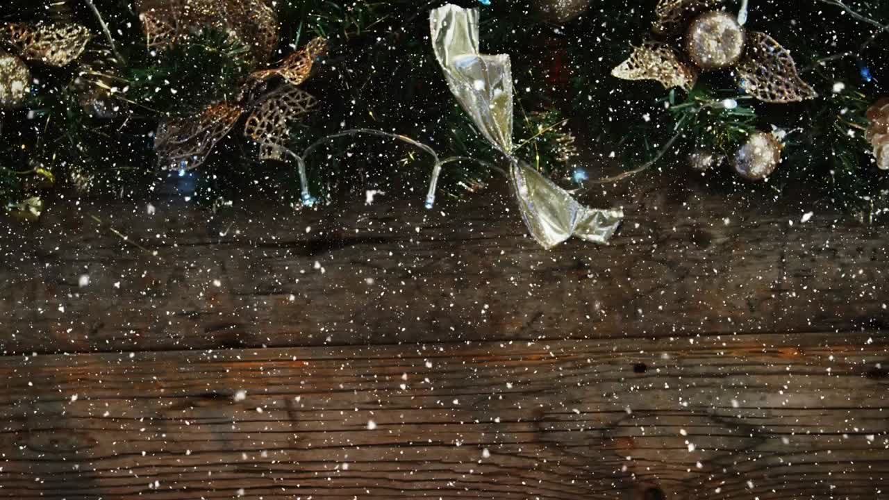 Video composition with snow over desk with Christmas decoration