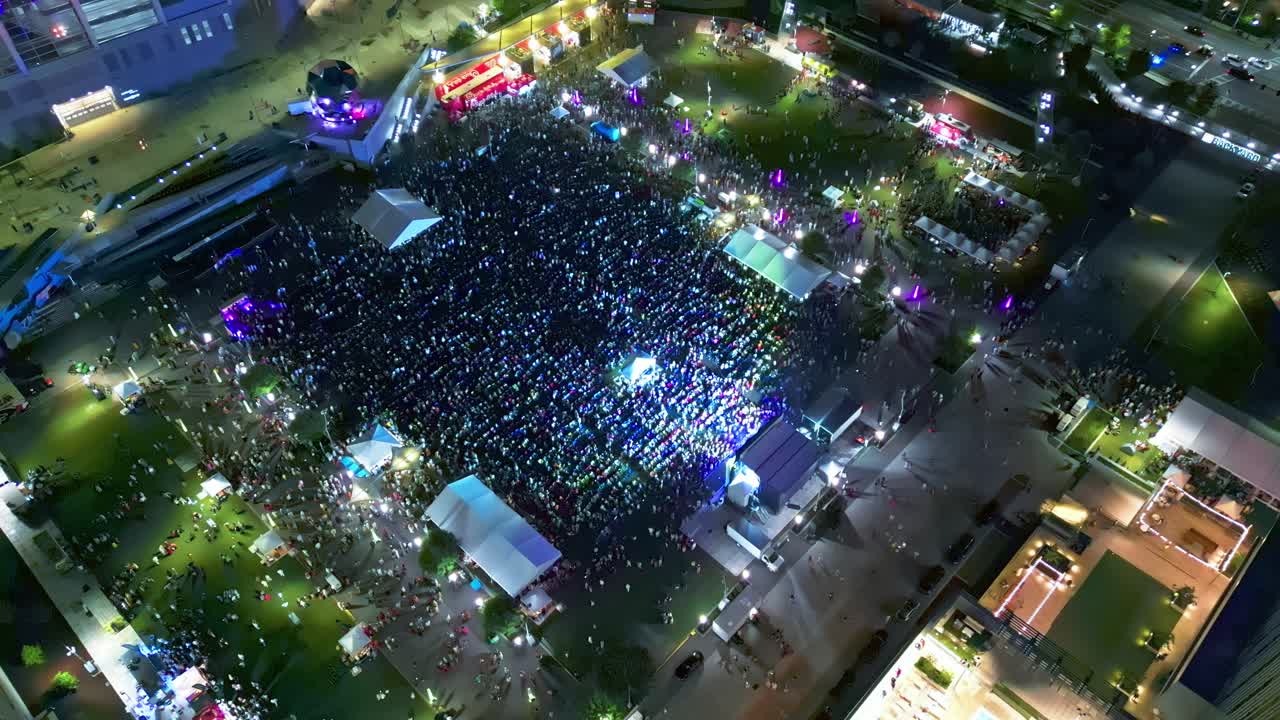 Outdoor Party Festival in Atlanta City. Flashing lights of stage. Open air music event. Aerial top down shot. Georgia, USA at night