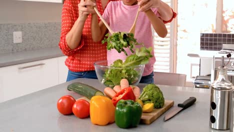 mother and daughter making salad