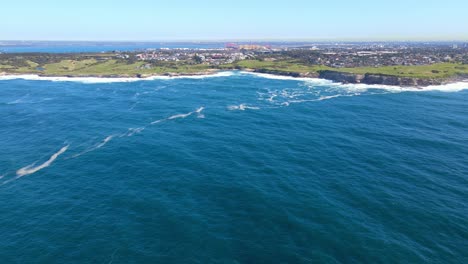 distant view of the greenfield with the townscape at the coastline of little bay in south-eastern sydney, australia