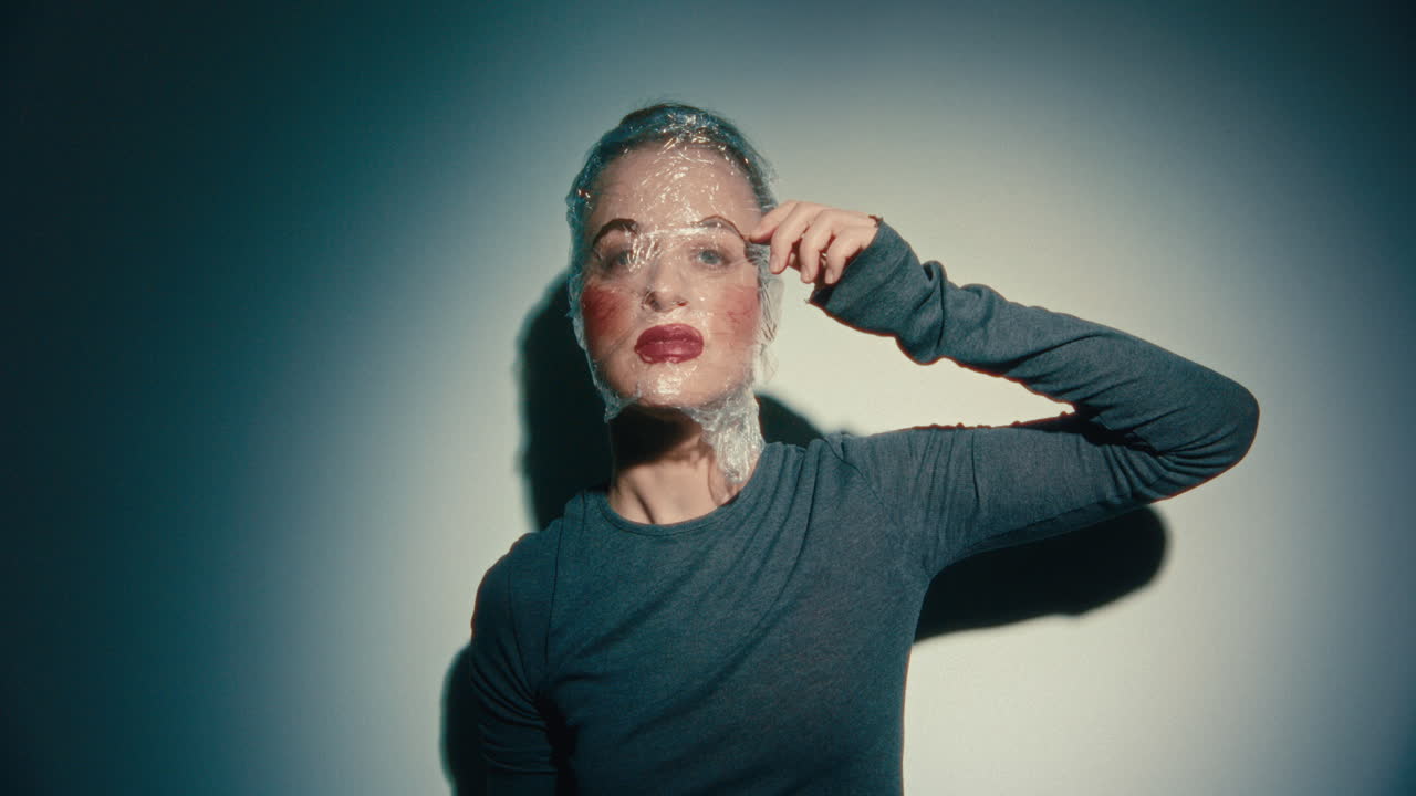 Woman with Plastic Wrap over Face